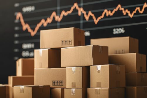 A stack of cardboard boxes in front of a financial chart. This image symbolizes commerce, logistics, and inventory management in modern business environments.