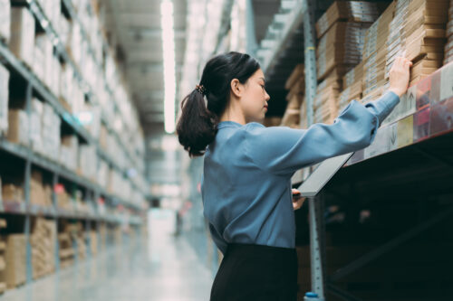 inventory manager checking inventory in warehouse