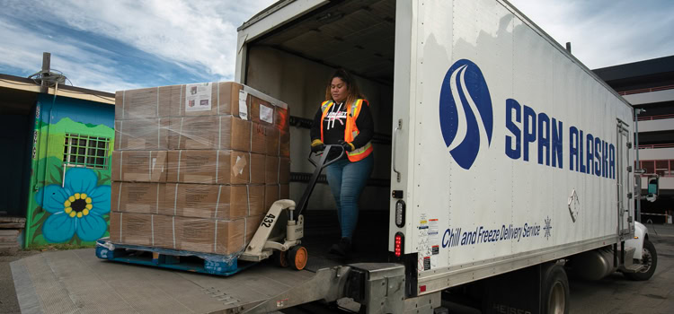 Image of Span Alaska's truck and employee for Alaska Supplement.