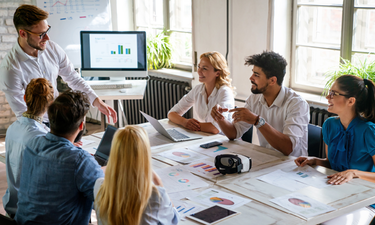 Photo of a team of young professionals working around a table.