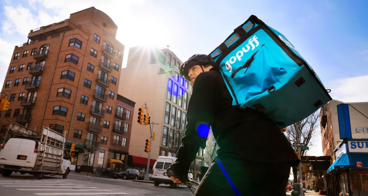 Photo of a GoPuff delivery person on a bike.
