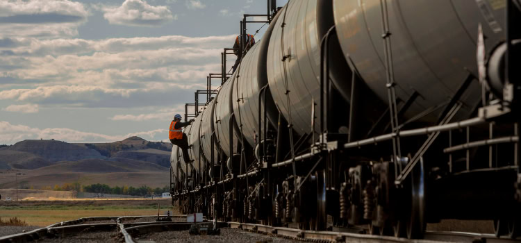 In Brief image of man on side of train oil car.