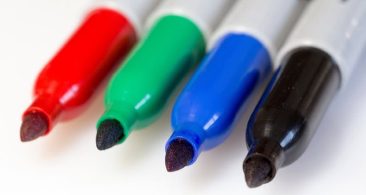 Photo of red, green, blue, and black Sharpies.