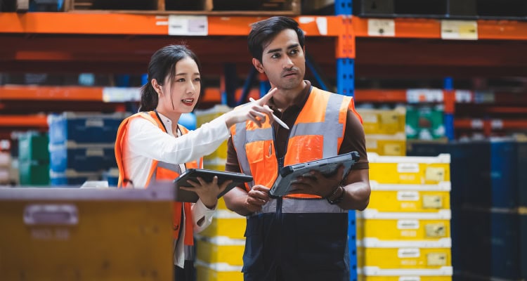 Photo of 2 workers in a warehouse.