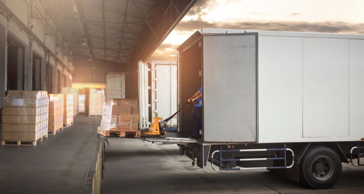 Image of a truck getting loaded at a warehouse.