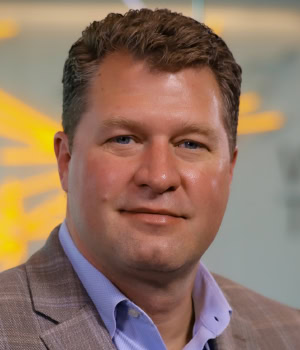 Headshots of Mark KunarCEO, DHL Supply Chain North America. 