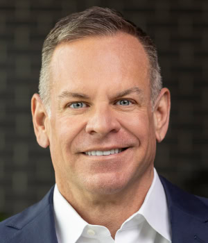 Headshot of Tom Madine, CEO, WWEX Group.