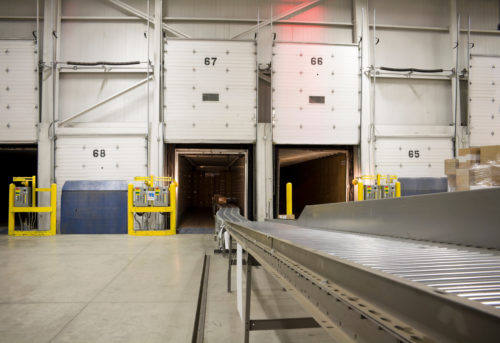 Conveyor belt in cross dock loading packages to back of truck