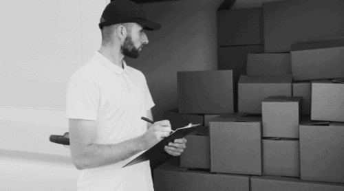 employee managing inventory with clipboard