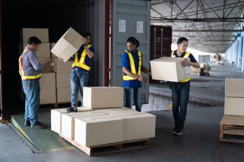 warehouse workers unloading boxes and balancing inventory levels in ABC analysis
